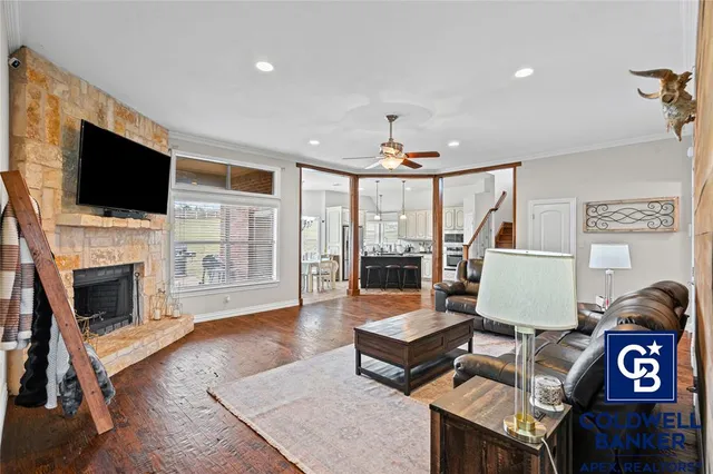 a living room with furniture a flat screen tv and a fireplace