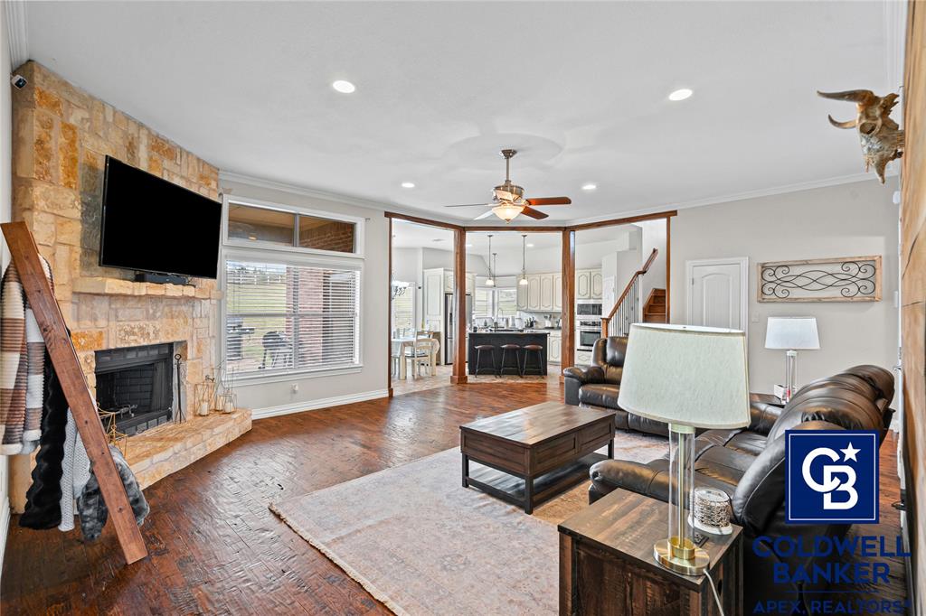 1316 Prairie Point Rhome, TX 76078 - Photo 6 of 30 a living room with furniture a flat screen tv and a fireplace