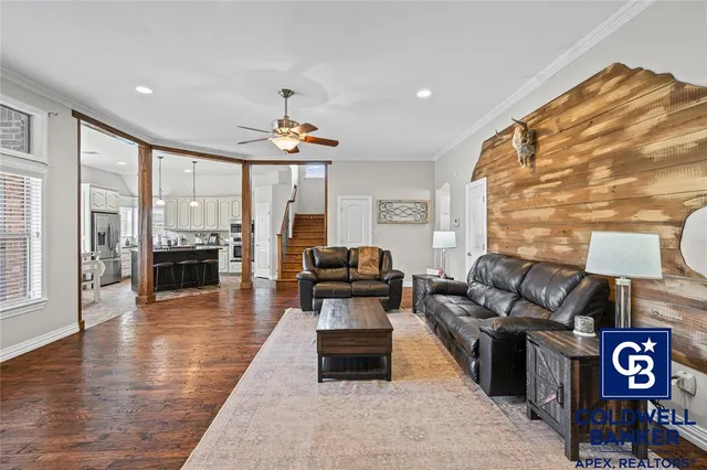 a living room with furniture and wooden floor