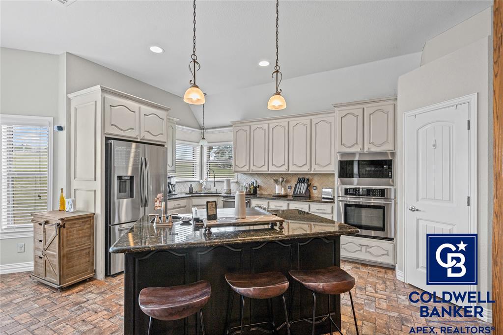 1316 Prairie Point Rhome, TX 76078 - Photo 9 of 30 a kitchen with granite countertop a sink appliances and cabinets