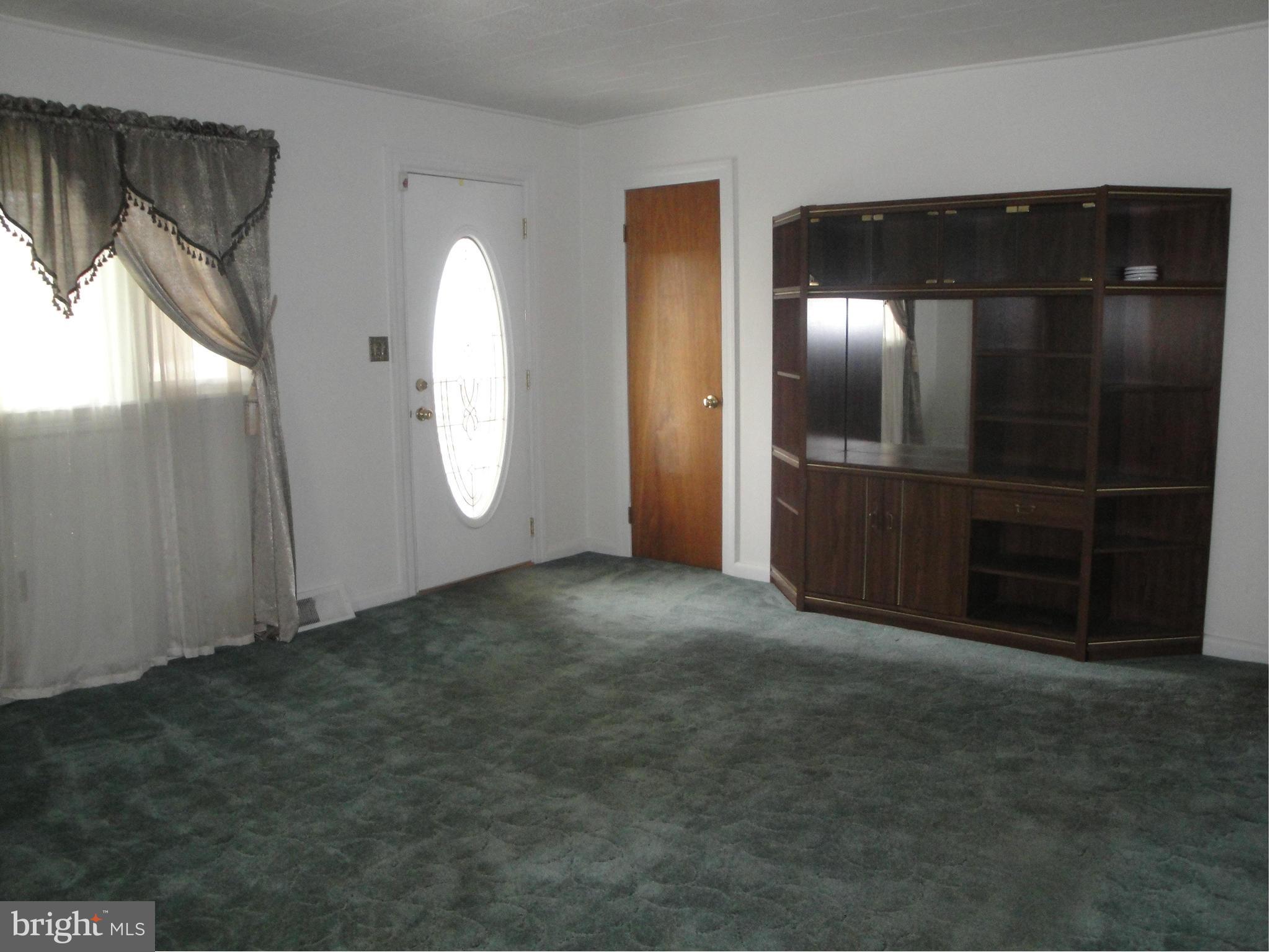 903 Bengies Road Baltimore, MD 21220 - Photo 5 of 18 a view of an empty room with a fireplace