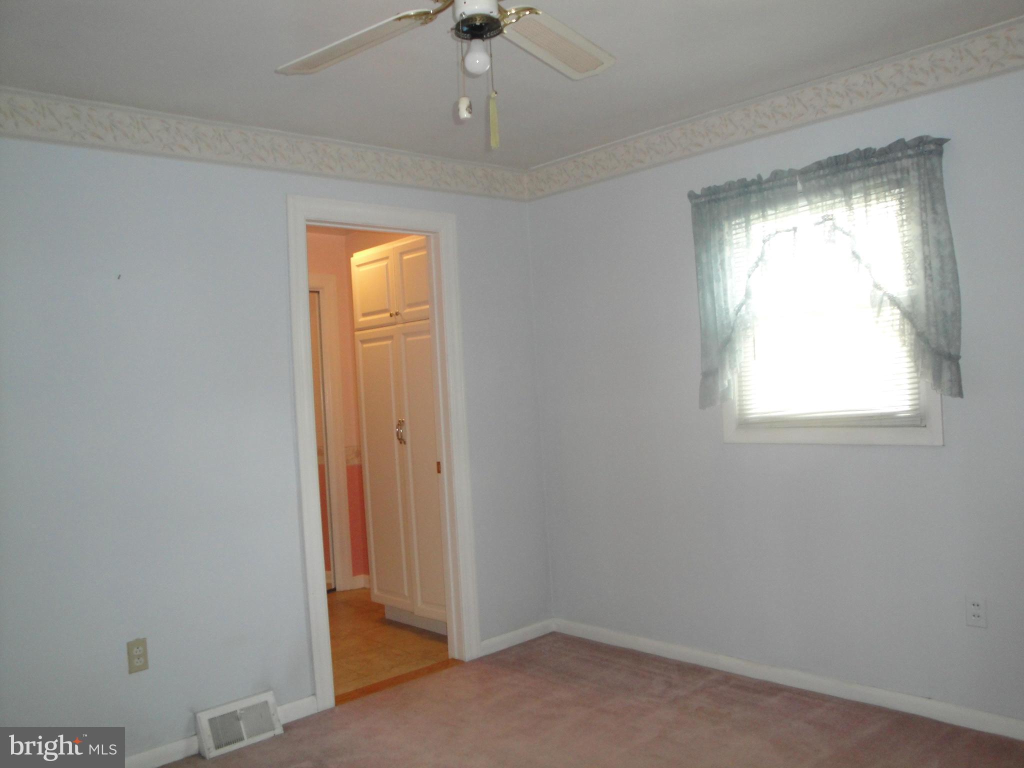 903 Bengies Road Baltimore, MD 21220 - Photo 10 of 18 an empty room with a window and a chandelier