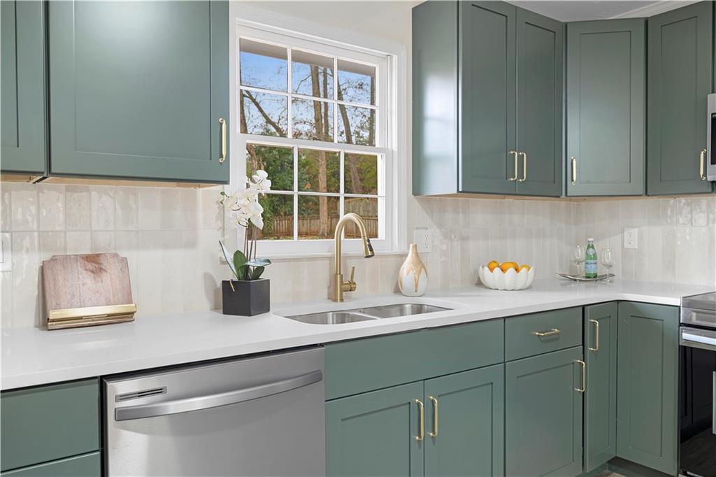 3905 Hunters Chase Southwest Conyers, GA 30094 - Photo 12 of 29 a kitchen with a sink and cabinets