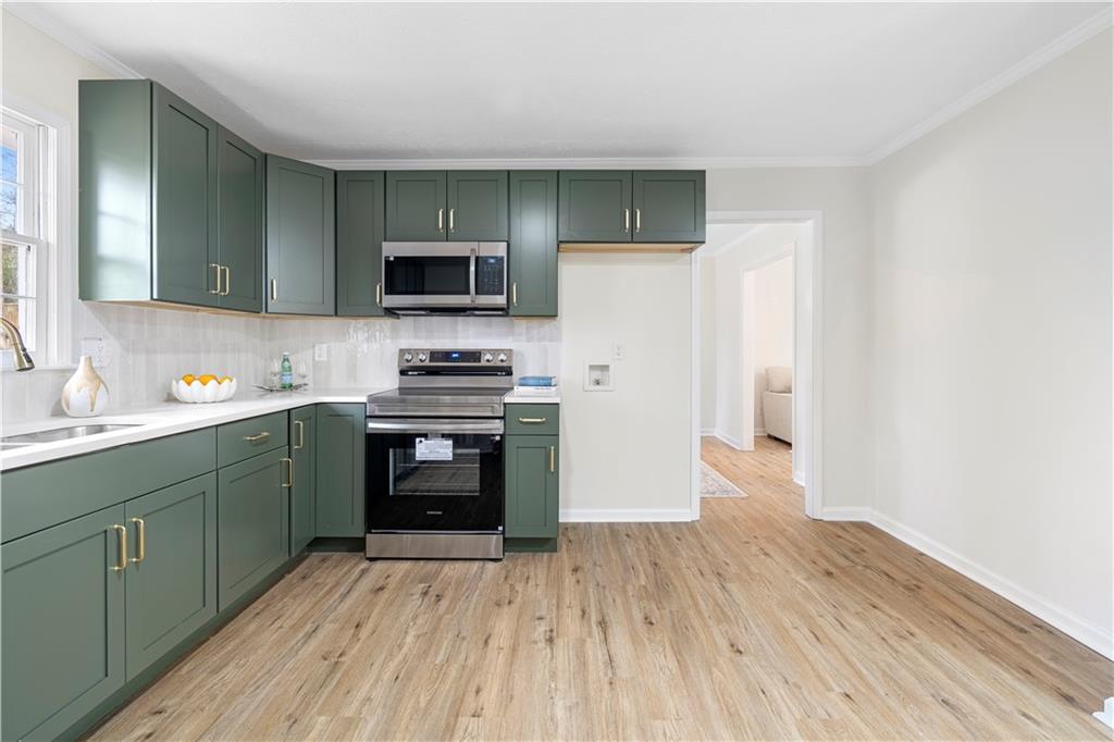 3905 Hunters Chase Southwest Conyers, GA 30094 - Photo 13 of 29 a kitchen with a refrigerator and a stove top oven