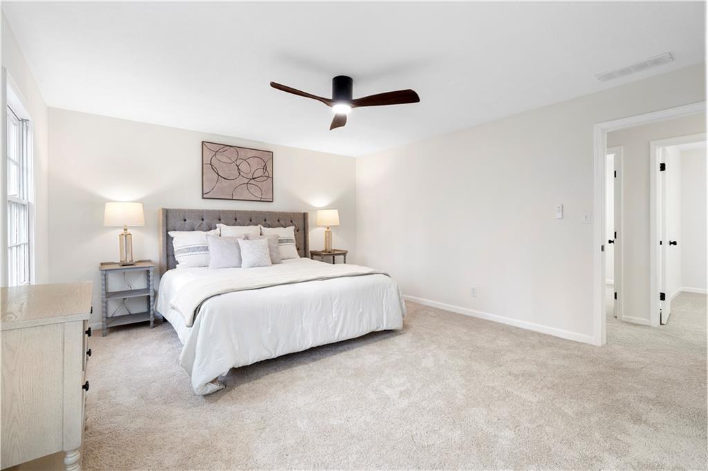 3905 Hunters Chase Southwest Conyers, GA 30094 - Photo 19 of 29 a bedroom with a bed and a painting on the wall