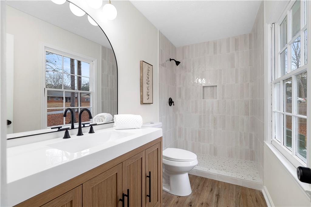 3905 Hunters Chase Southwest Conyers, GA 30094 - Photo 20 of 29 a bathroom with a sink a toilet and shower