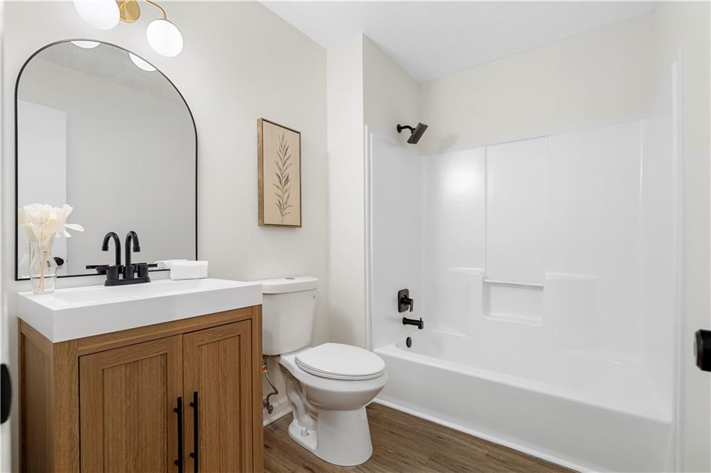 3905 Hunters Chase Southwest Conyers, GA 30094 - Photo 23 of 29 a bathroom with a sink a toilet and shower