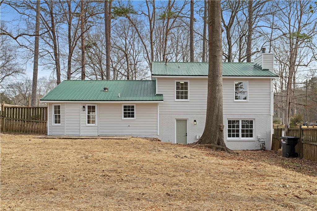 3905 Hunters Chase Southwest Conyers, GA 30094 - Photo 25 of 29 a front view of a house with a yard and garage