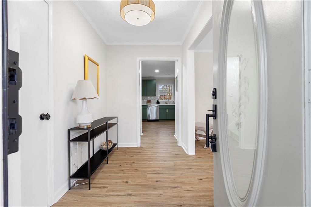 3905 Hunters Chase Southwest Conyers, GA 30094 - Photo 4 of 29 a view of a hallway view with wooden floor and staircase