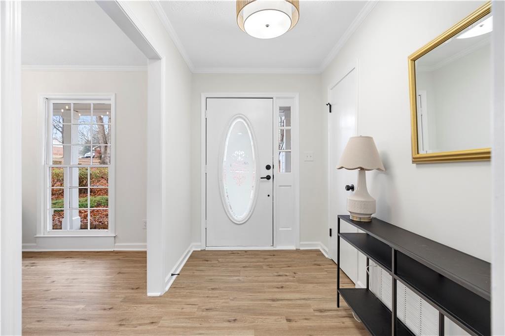 3905 Hunters Chase Southwest Conyers, GA 30094 - Photo 5 of 29 a view of a livingroom with wooden floor and entryway