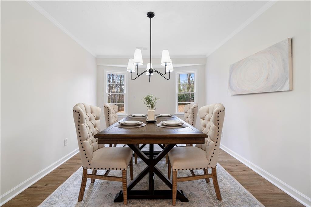 3905 Hunters Chase Southwest Conyers, GA 30094 - Photo 7 of 29 a view of a dining room with furniture window and wooden floor