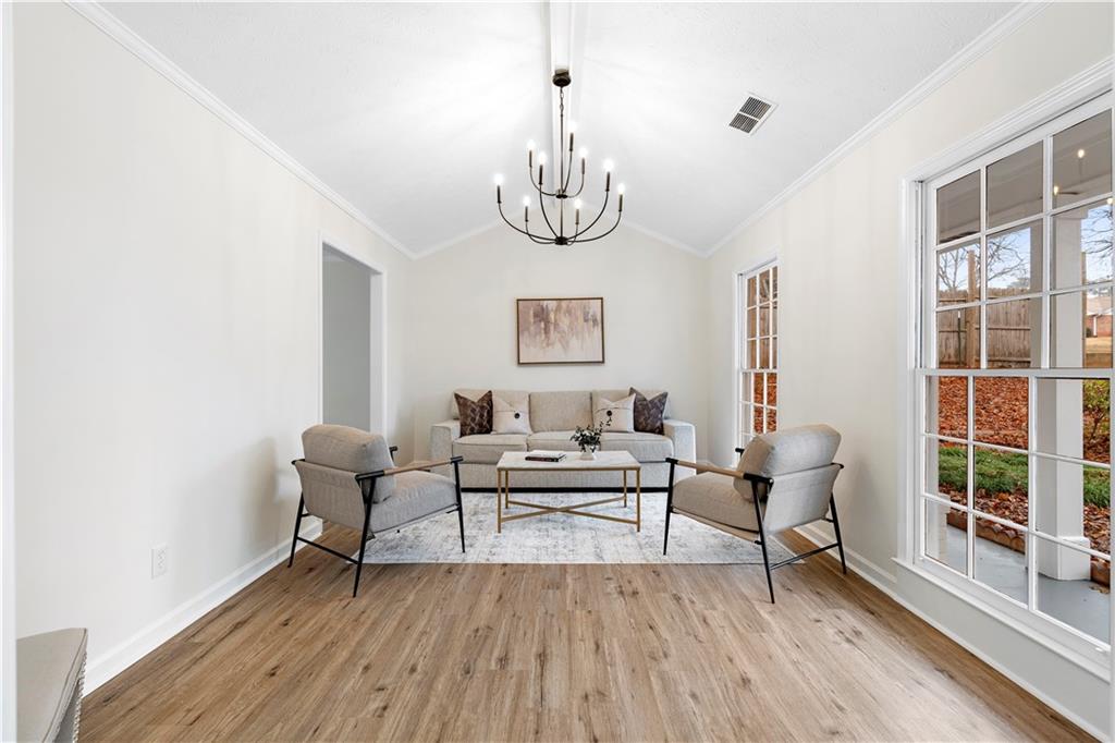 3905 Hunters Chase Southwest Conyers, GA 30094 - Photo 8 of 29 a living room with furniture two window and wooden floor