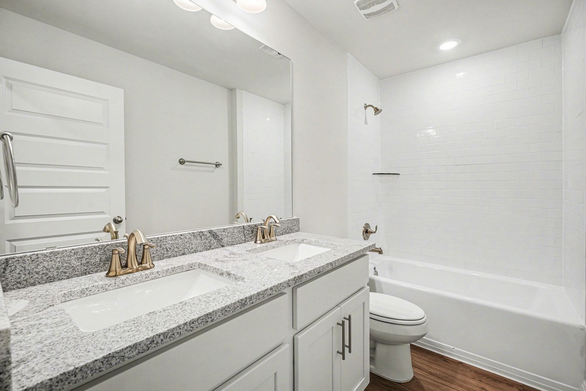 5 Keystone Court Angleton, TX 77515 - Photo 28 of 33 a bathroom with a granite countertop sink a toilet and bathtub