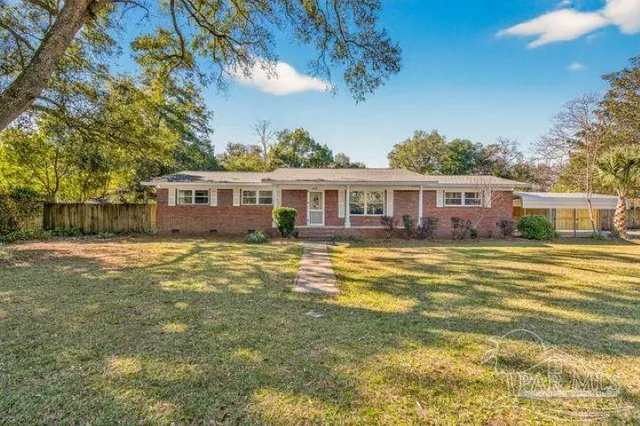 a view of a swimming pool in front of the house