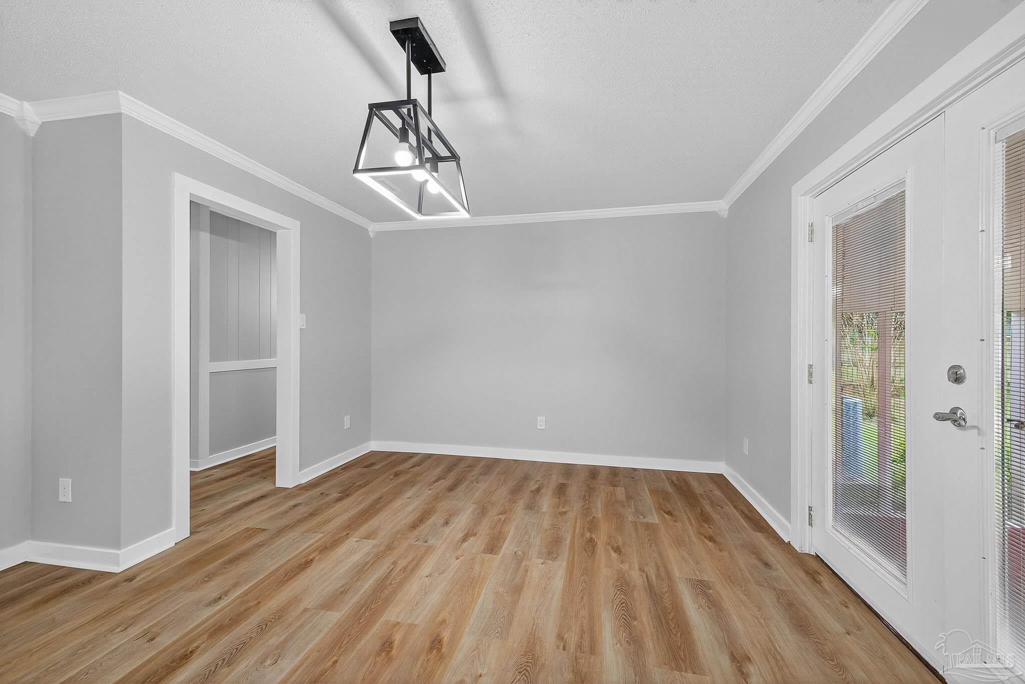 4673 Van Horn Road Milton, FL 32583 - Photo 13 of 48 a view of empty room with wooden floor and ceiling fan