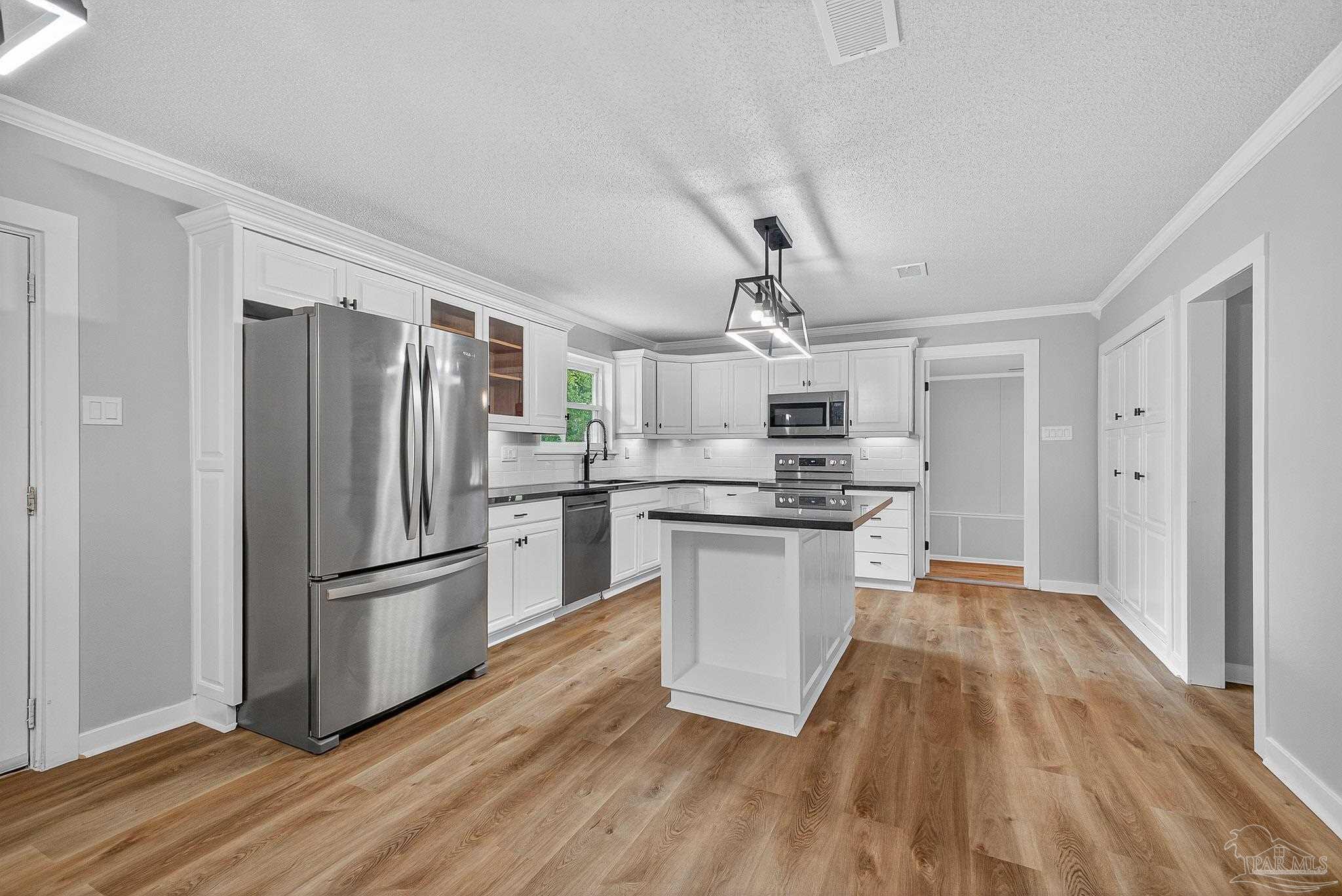 4673 Van Horn Road Milton, FL 32583 - Photo 14 of 48 a kitchen with stainless steel appliances a refrigerator sink and microwave
