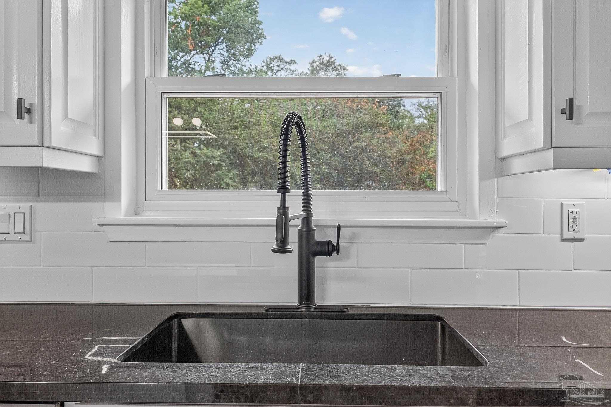 4673 Van Horn Road Milton, FL 32583 - Photo 16 of 48 a kitchen with a sink and large window