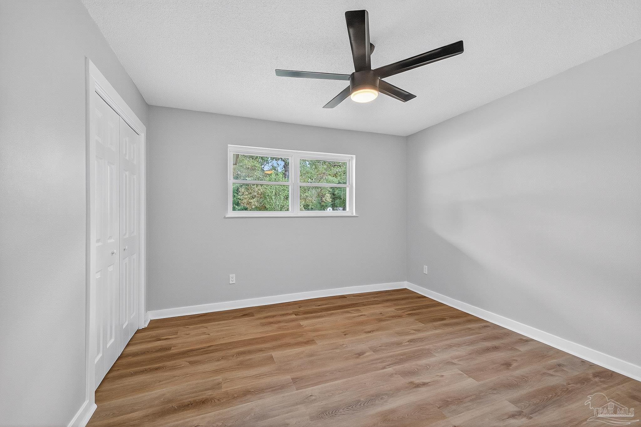 4673 Van Horn Road Milton, FL 32583 - Photo 26 of 48 a view of empty room with wooden floor