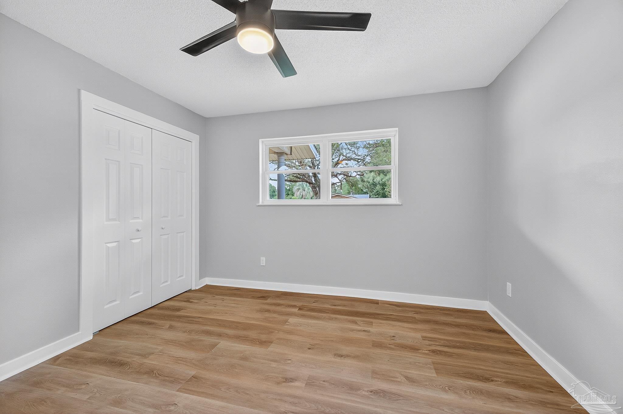 4673 Van Horn Road Milton, FL 32583 - Photo 27 of 48 wooden floor in an empty room with a window