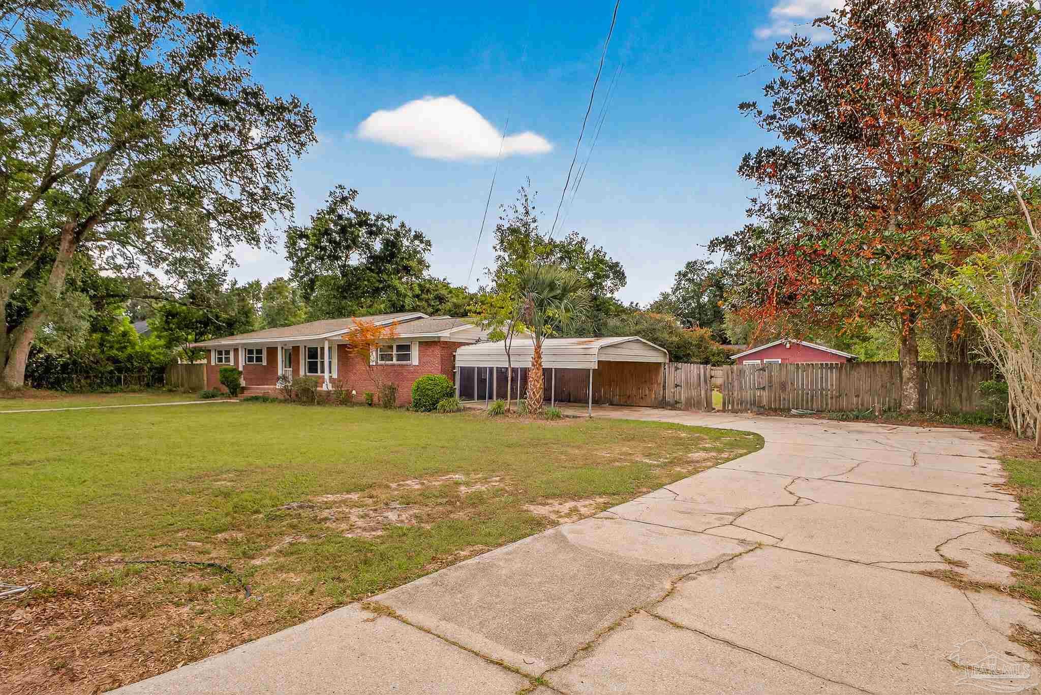 4673 Van Horn Road Milton, FL 32583 - Photo 3 of 48 a front view of a house with a garden