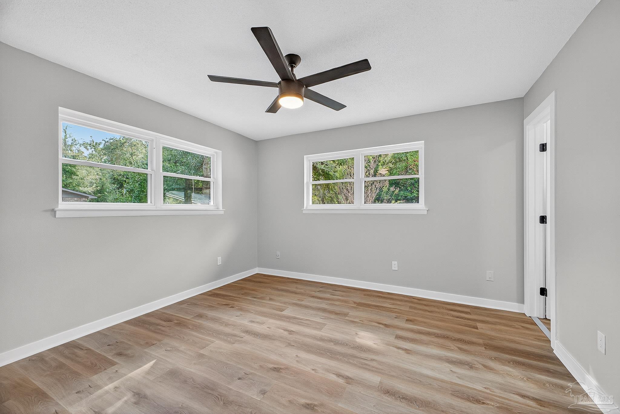 4673 Van Horn Road Milton, FL 32583 - Photo 36 of 48 a view of empty room with wooden floor and fan