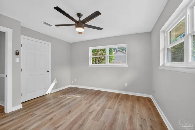 wooden floor in an empty room with a window