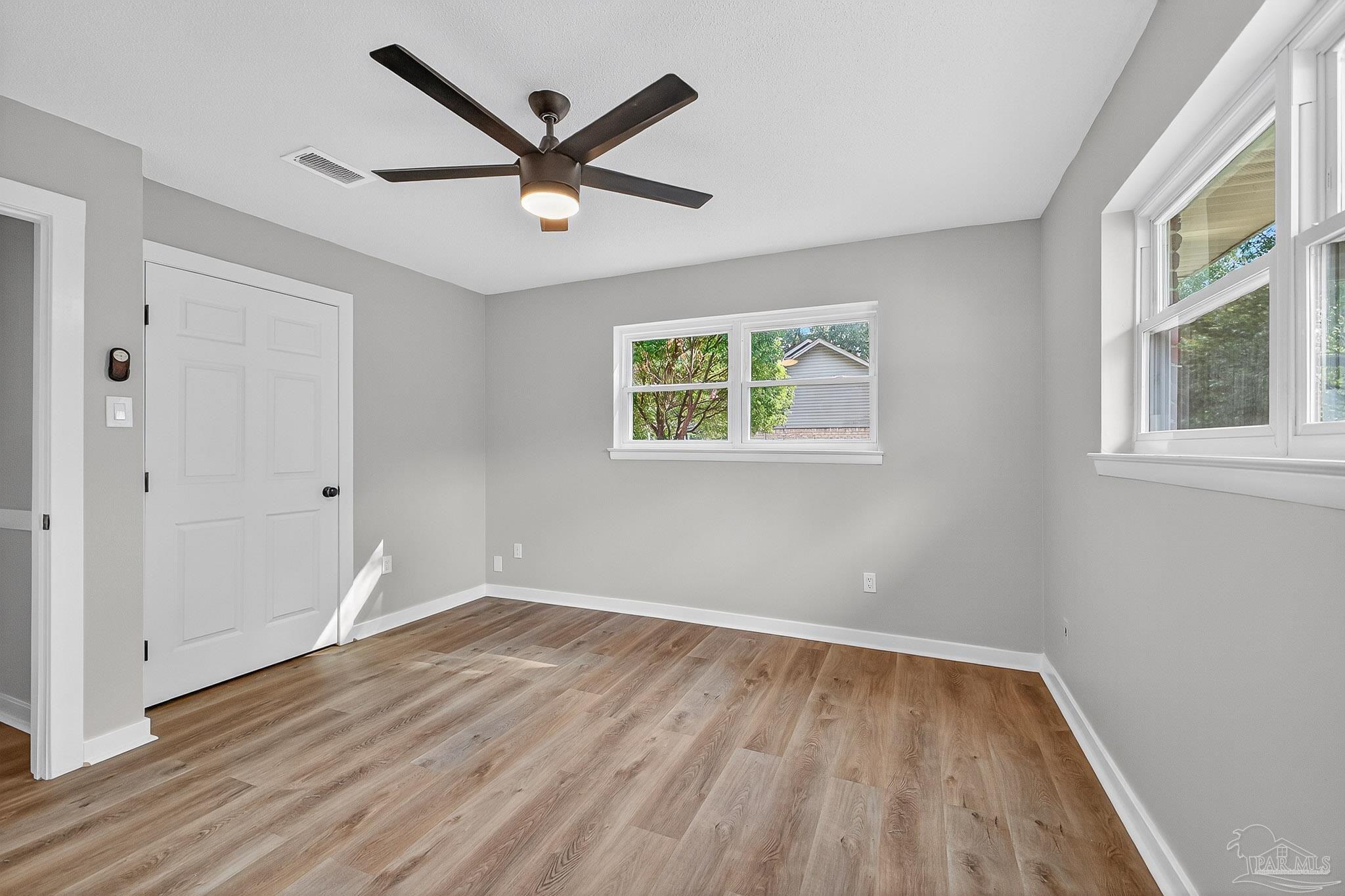 4673 Van Horn Road Milton, FL 32583 - Photo 37 of 48 wooden floor in an empty room with a window