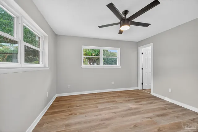 wooden floor in an empty room with a window