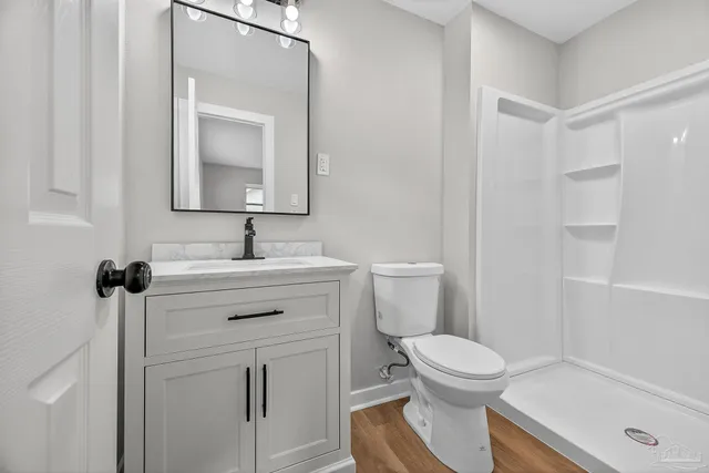 a bathroom with a sink toilet and shower