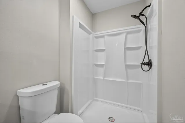 a bathroom with a shower and toilet