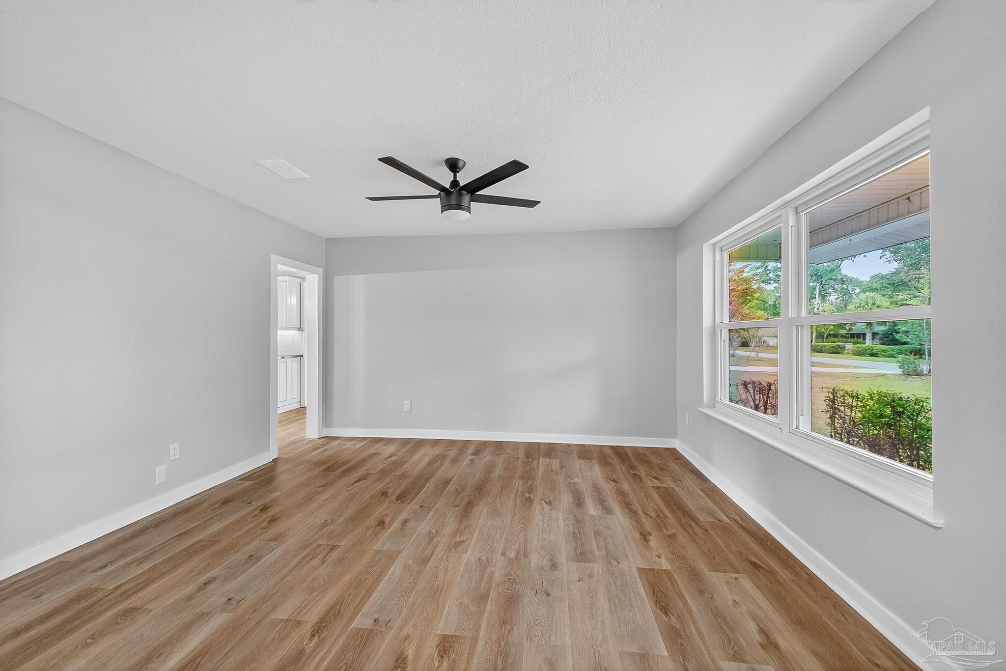 4673 Van Horn Road Milton, FL 32583 - Photo 6 of 48 a view of empty room with wooden floor and fan