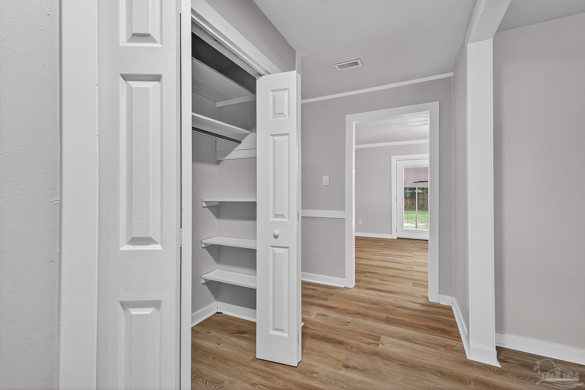 4673 Van Horn Road Milton, FL 32583 - Photo 9 of 48 a view of a hallway with wooden floor and closet