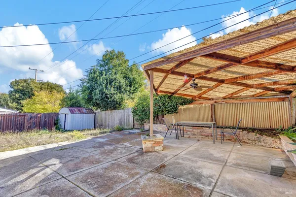 a backyard of a house with table and chairs