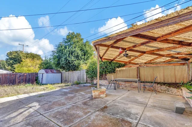 a backyard of a house with table and chairs
