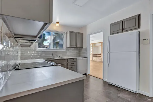 a kitchen with a refrigerator and a refrigerator