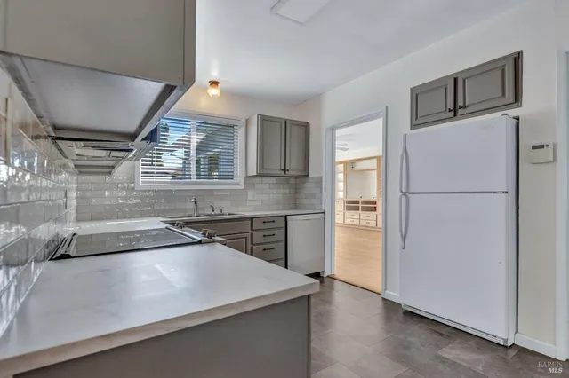 a kitchen with a refrigerator and a refrigerator