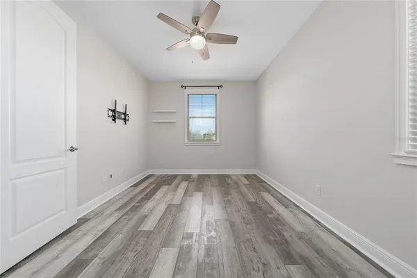 wooden floor in an empty room with a window