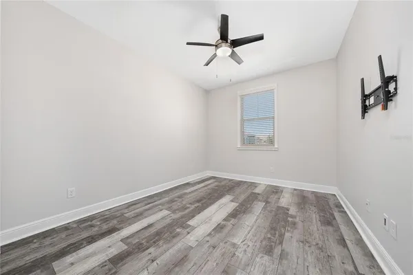 a view of a room with a ceiling fan and a window