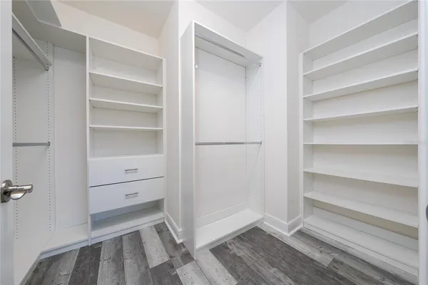 a view of walk in closet with empty racks