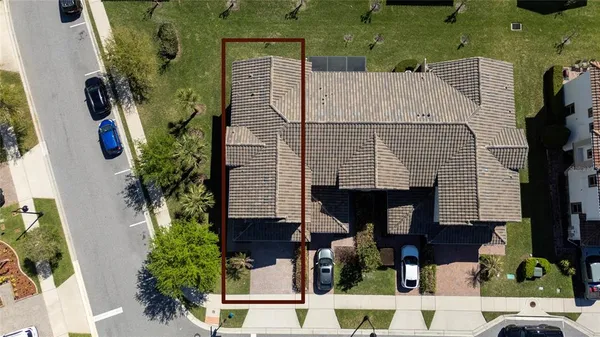 an aerial view of a house with swimming pool and garden