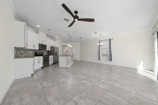 a open kitchen with cabinets and stainless steel appliances