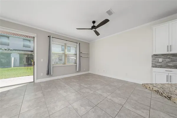a view of an empty room with window and cabinet