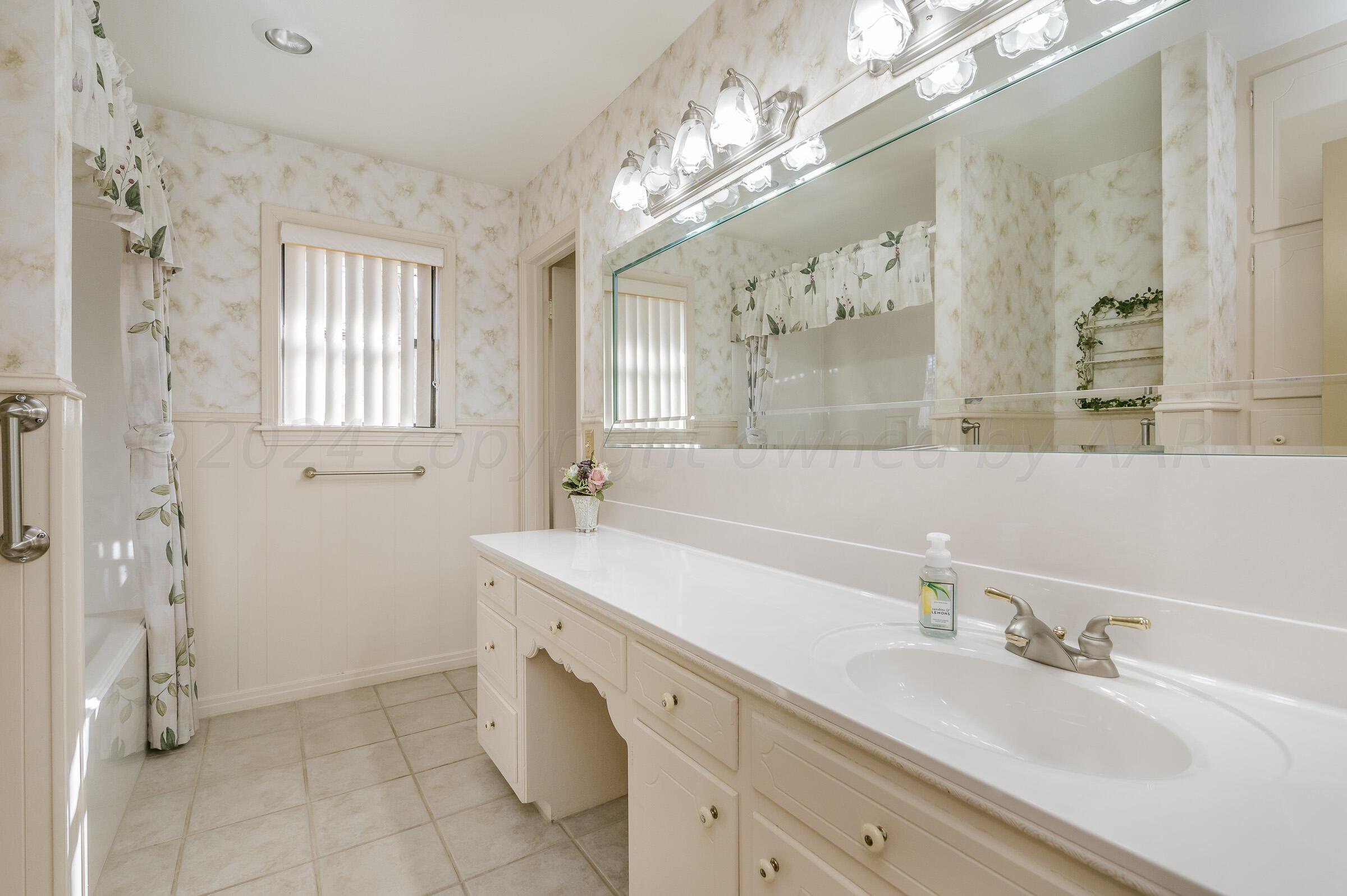 6113 Elmhurst Road Amarillo, TX 79106 - Photo 14 of 28 a bathroom with a double vanity sink mirror and shower