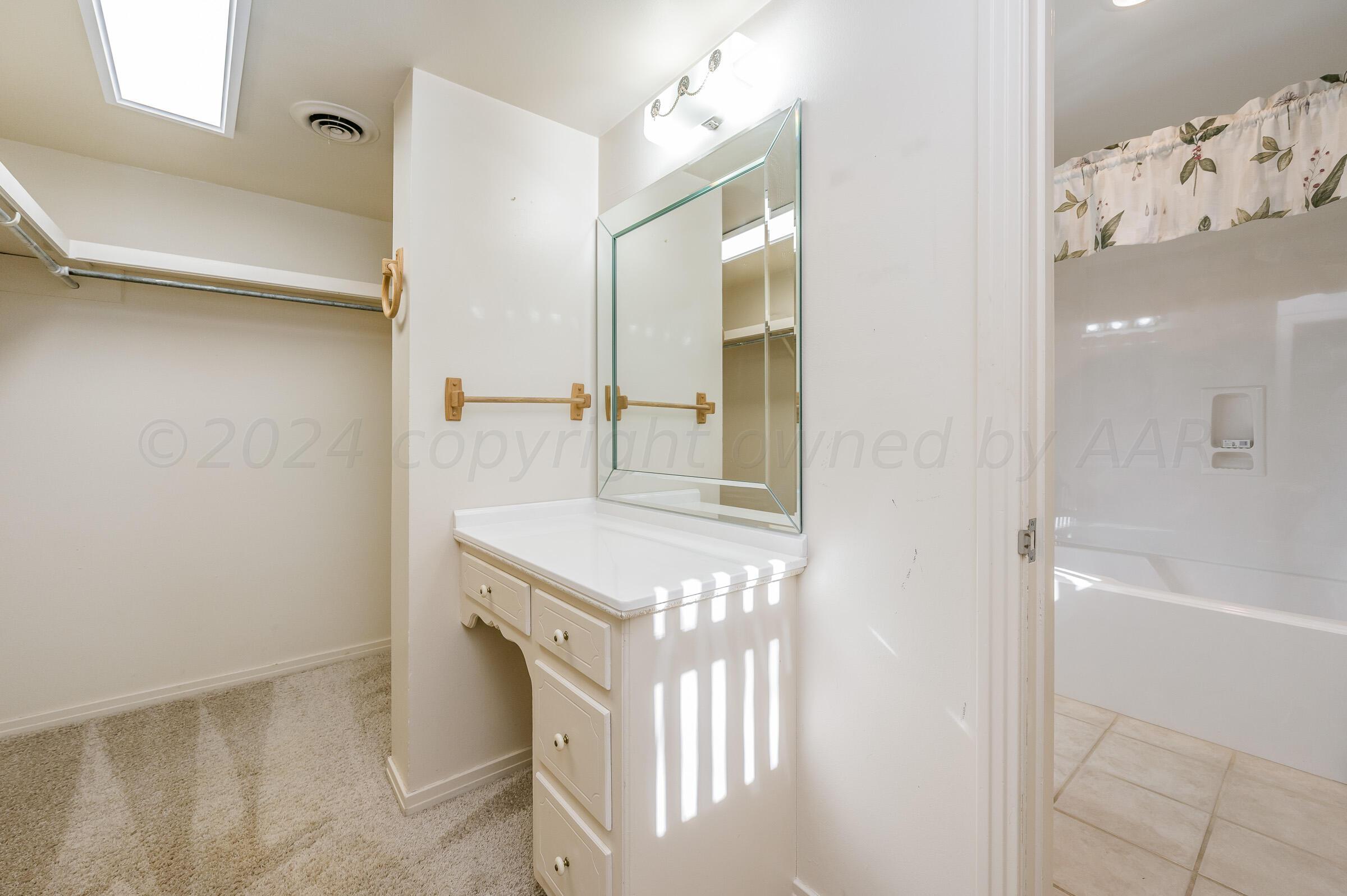 6113 Elmhurst Road Amarillo, TX 79106 - Photo 15 of 28 a bathroom with a sink and a mirror