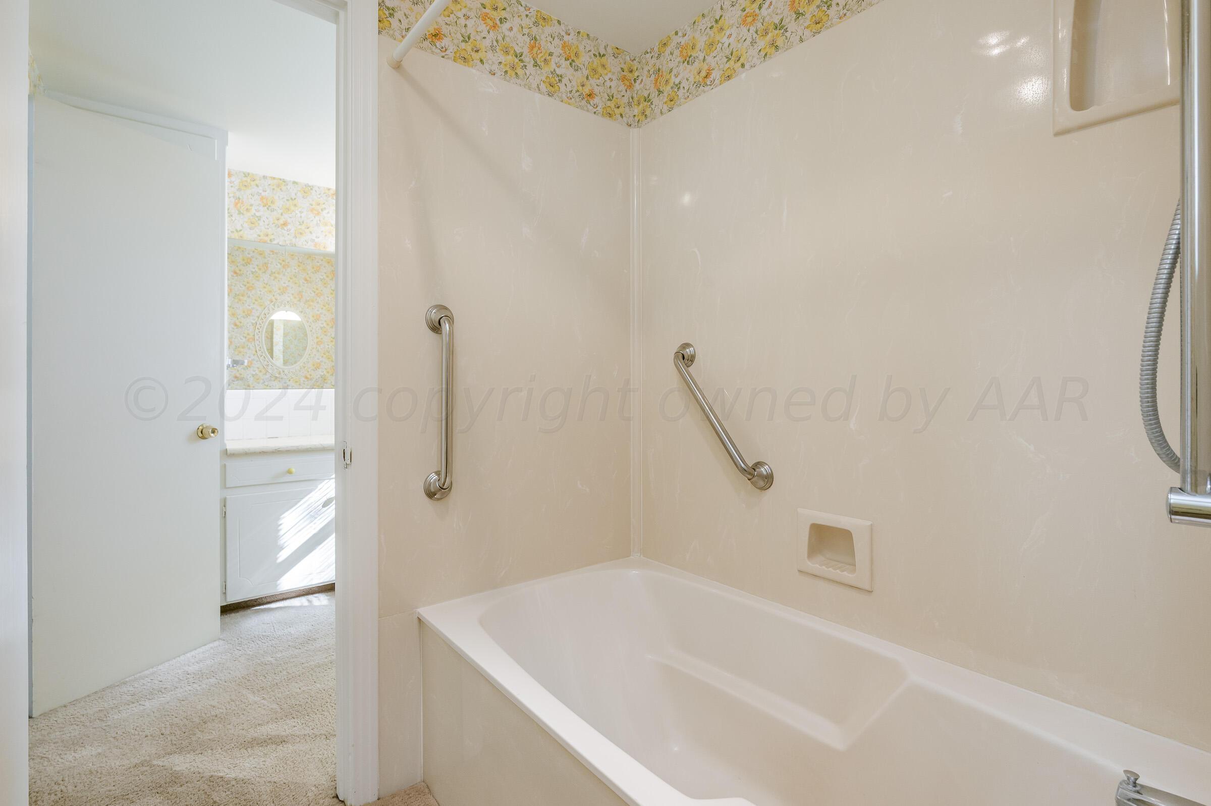 6113 Elmhurst Road Amarillo, TX 79106 - Photo 20 of 28 a bathroom with a bathtub and a shower