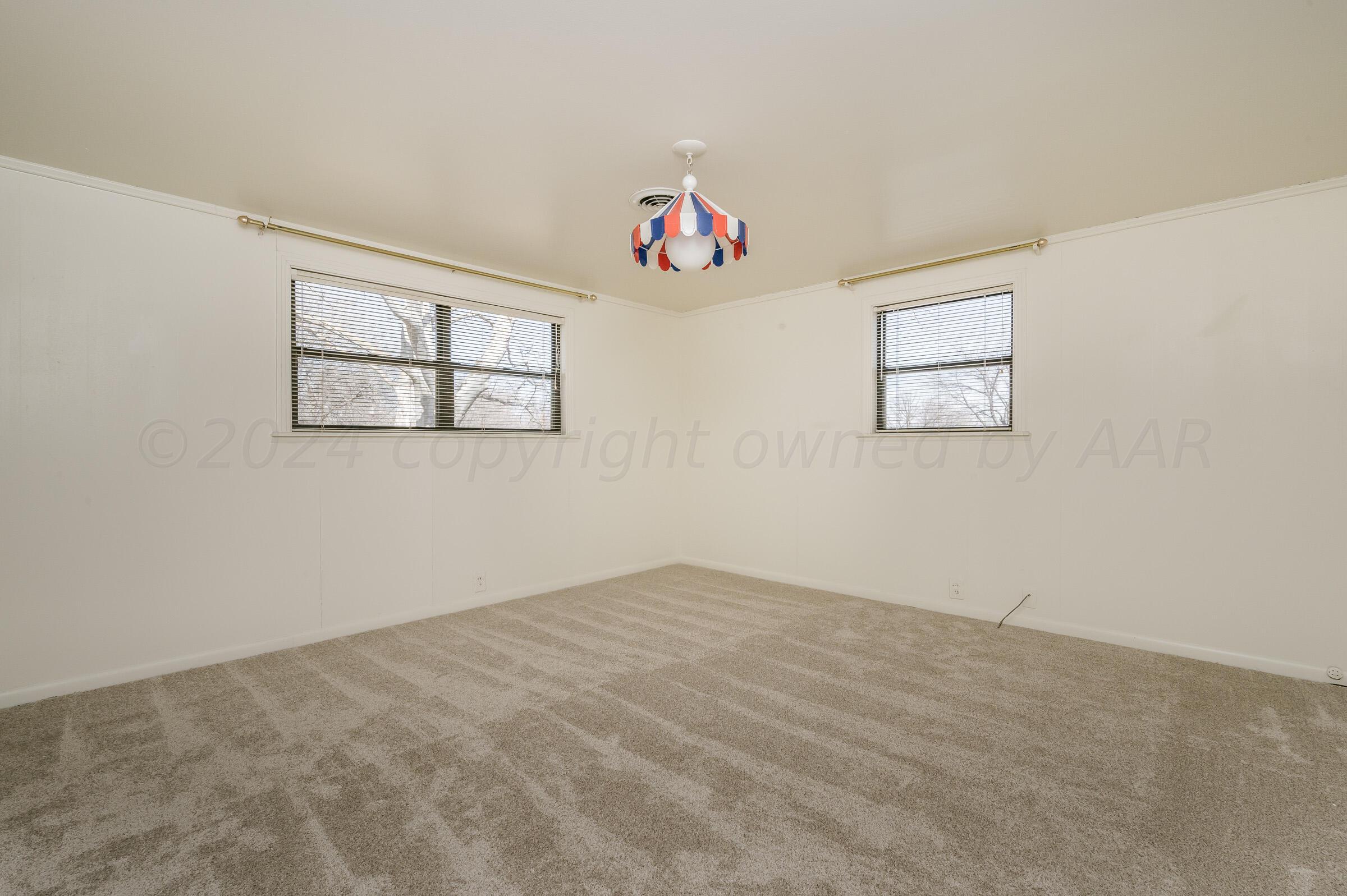 6113 Elmhurst Road Amarillo, TX 79106 - Photo 23 of 28 an empty room with windows