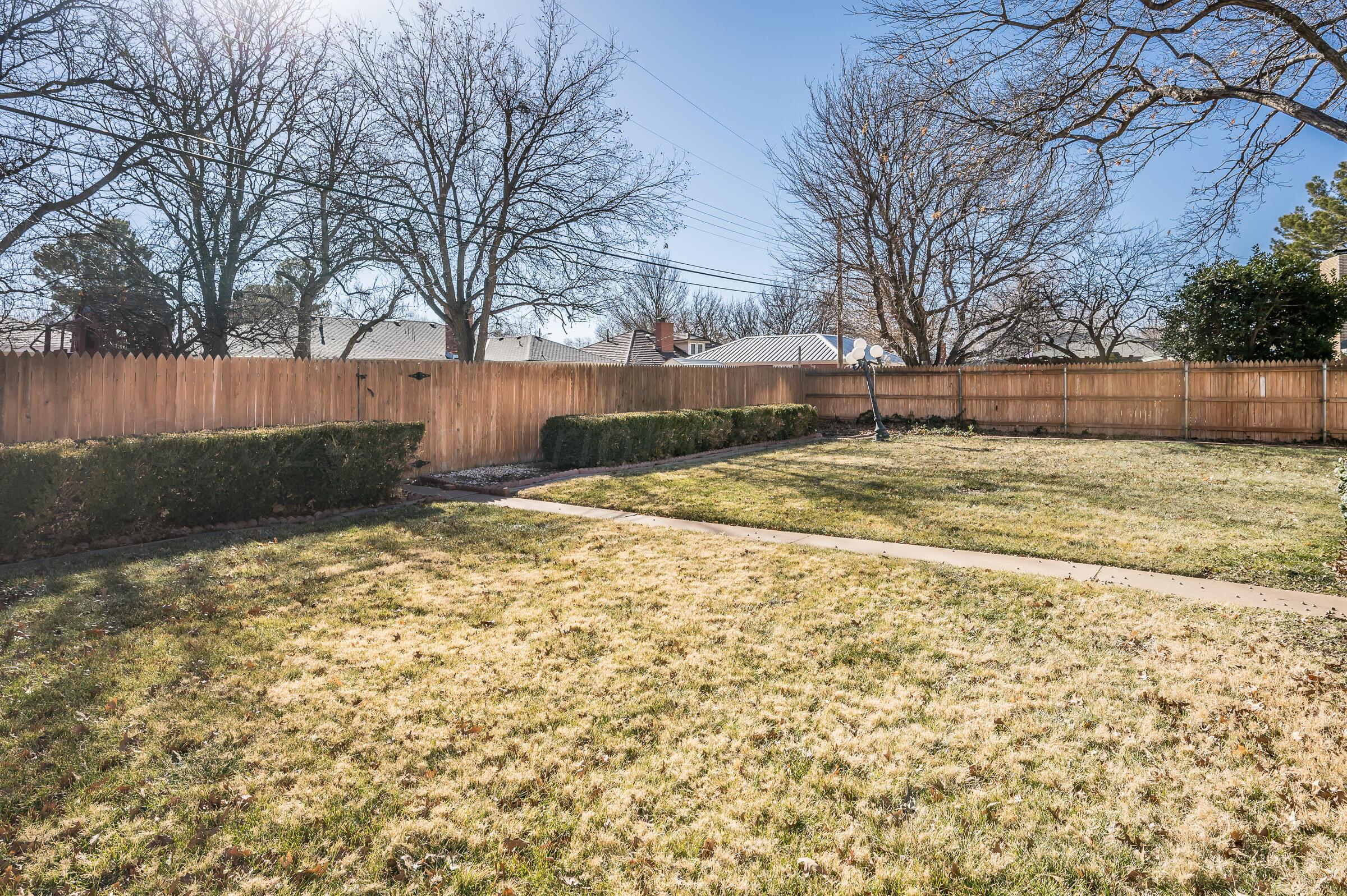 6113 Elmhurst Road Amarillo, TX 79106 - Photo 28 of 28 a view of a yard with trees