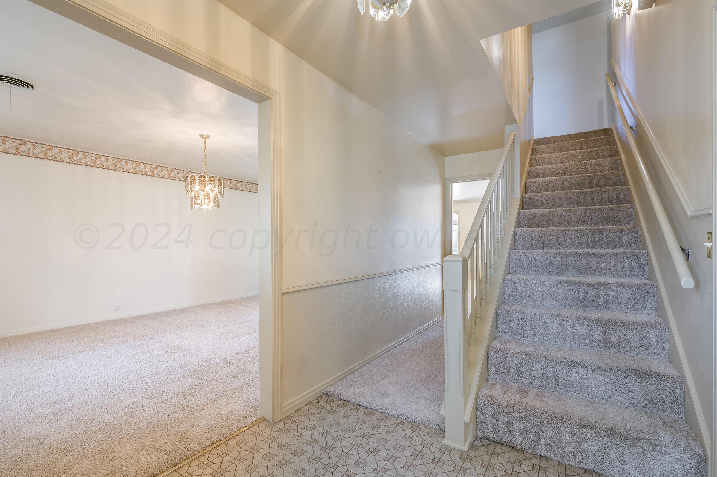 6113 Elmhurst Road Amarillo, TX 79106 - Photo 3 of 28 a view of a hallway with staircase