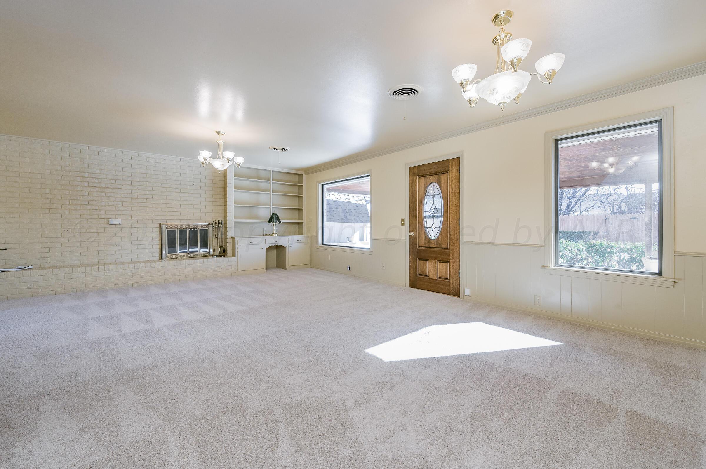 6113 Elmhurst Road Amarillo, TX 79106 - Photo 8 of 28 a view of a kitchen with granite countertop cabinets and chandelier fan