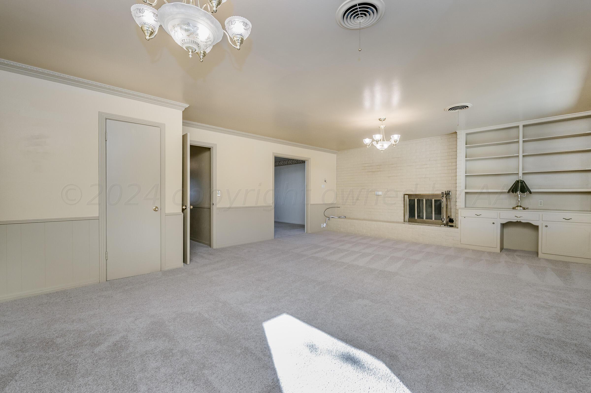 6113 Elmhurst Road Amarillo, TX 79106 - Photo 9 of 28 a view of a livingroom with a furniture and chandelier fan